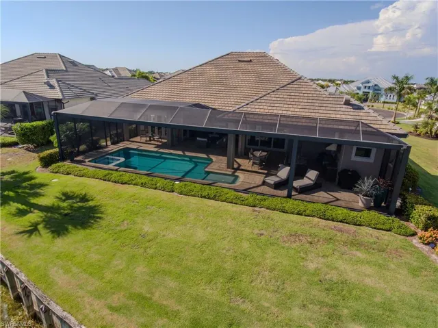 View of swimming pool with a yard, a lanai, and a patio area