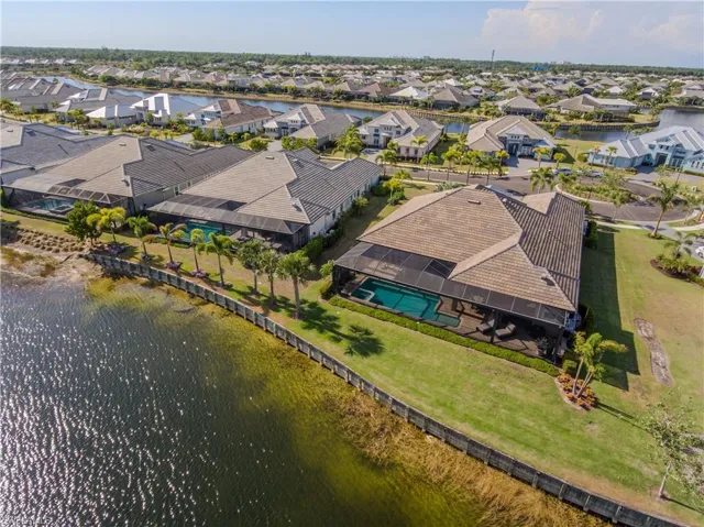 Birds eye view of property with a water view
