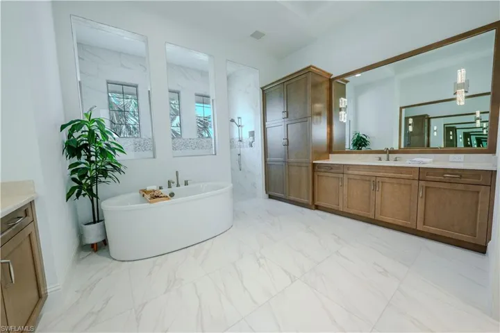 Bathroom featuring plus walk in shower and vanity