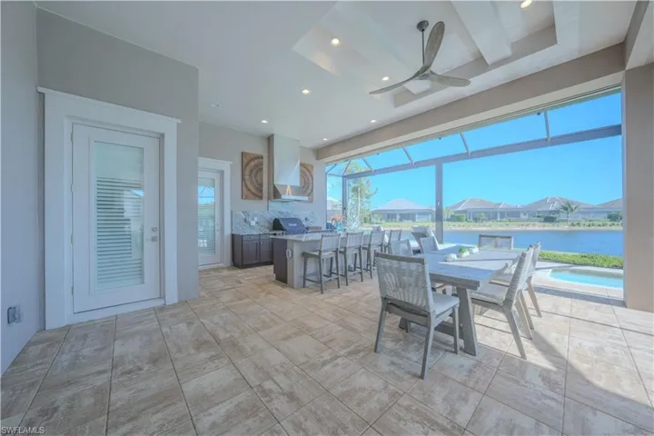 Dining space featuring ceiling fan and a water view