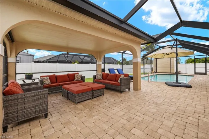 View of patio / terrace featuring an outdoor hangout area, a fenced in pool, and glass enclosure