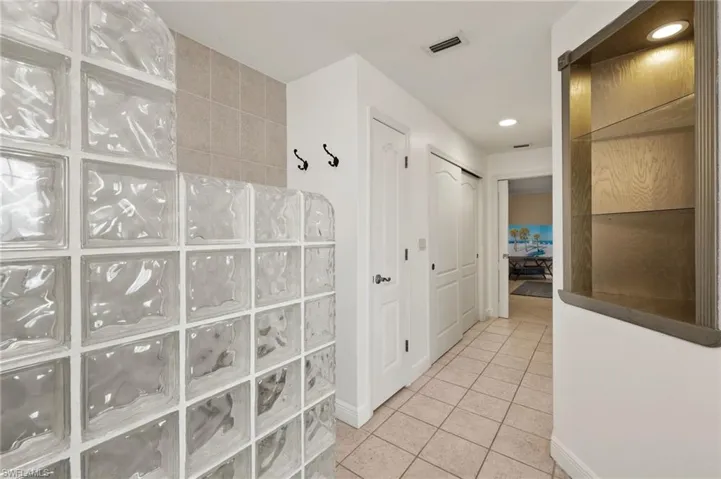 Hallway with light tile patterned flooring