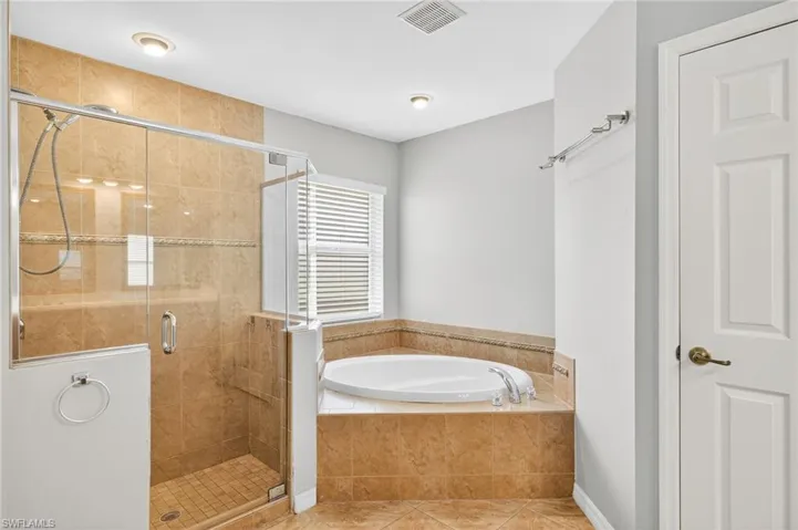 Full bath with a garden tub, a shower stall, and tile patterned floors