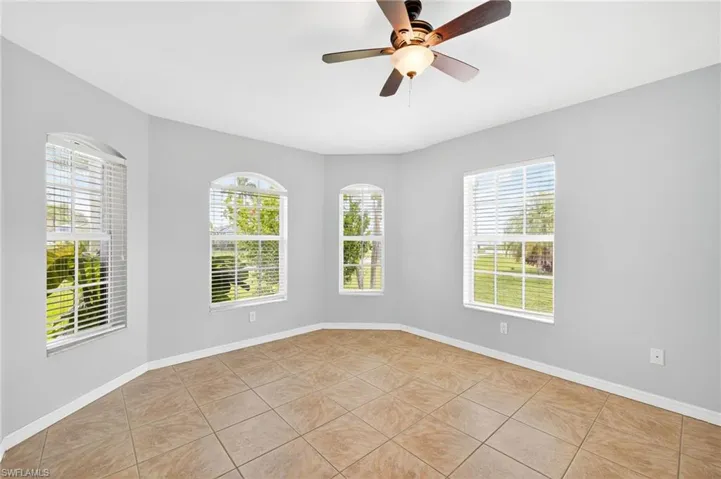 Spare room with light tile patterned floors and a ceiling fan