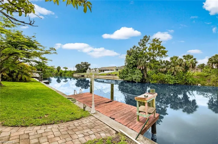 Dock featuring a water view and a lawn