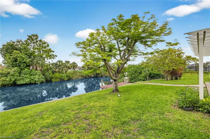 View of green lawn featuring a water view