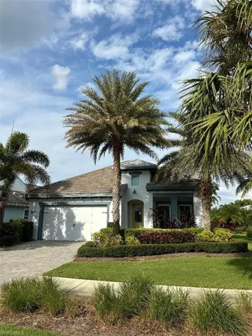 View of front of house featuring a front lawn and a garage