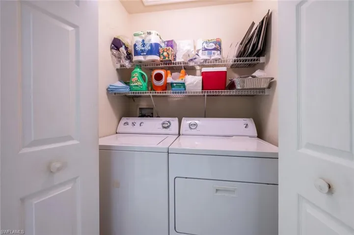 Laundry room with laundry area and washer and clothes dryer