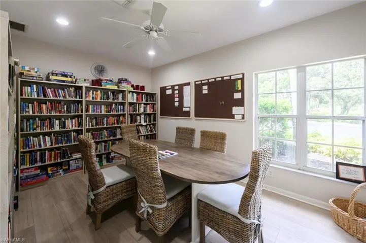 Dining area with baseboards, wood finished floors, a ceiling fan, and recessed lighting