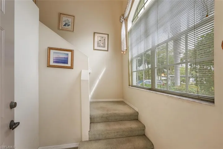 Staircase with carpet flooring and baseboards