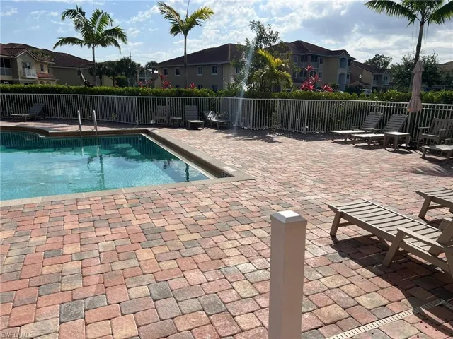 Pool with fence and a residential view