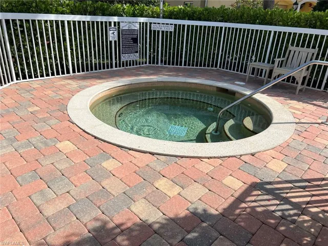 Details with fence and a hot tub