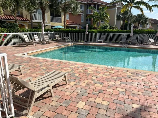 Pool featuring a patio and fence