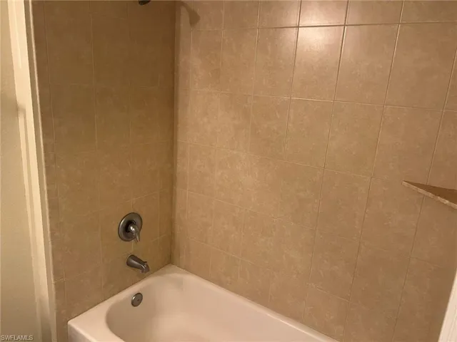 Full bathroom with shower / washtub combination