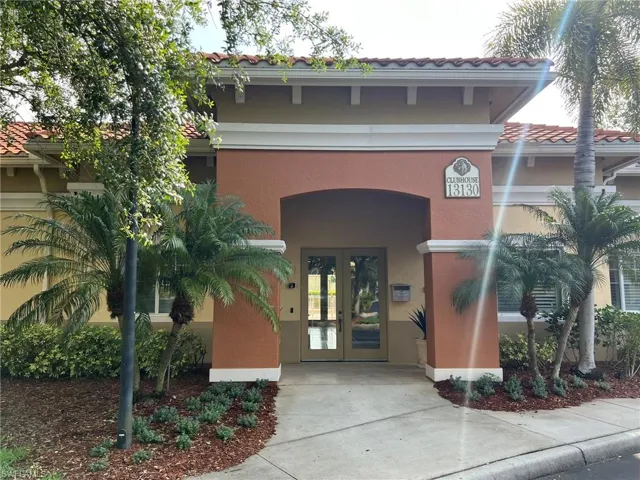Entrance to property with a tiled roof, french doors, and stucco siding
