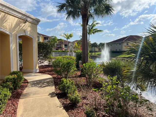 View of community featuring a water view, fence, and a residential view