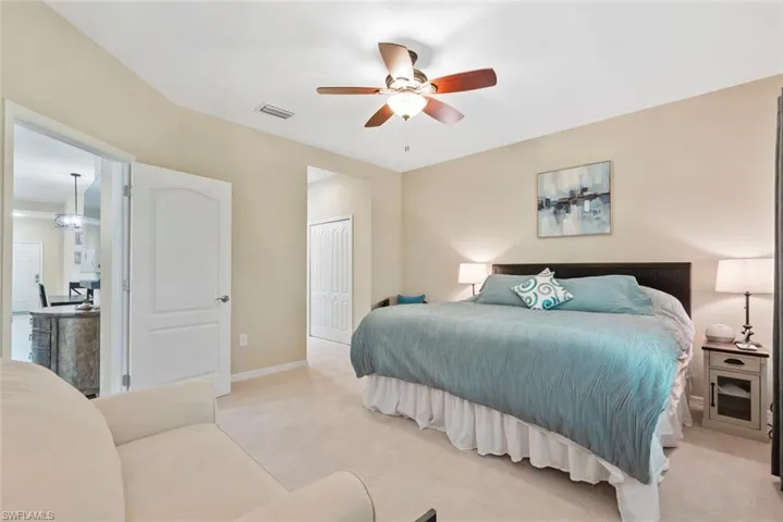 Bedroom featuring light carpet, a closet, and ceiling fan
