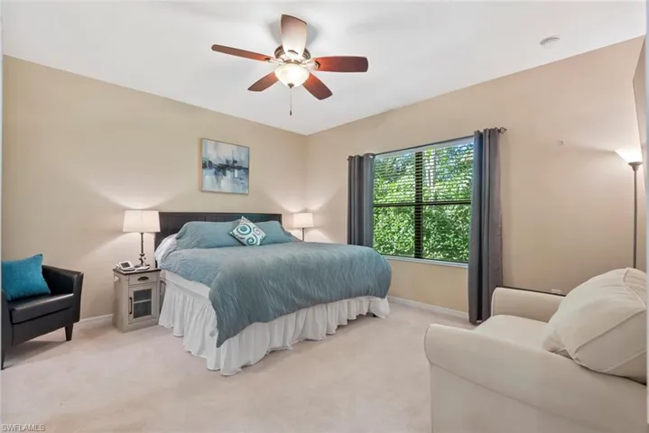 Bedroom featuring light carpet and ceiling fan