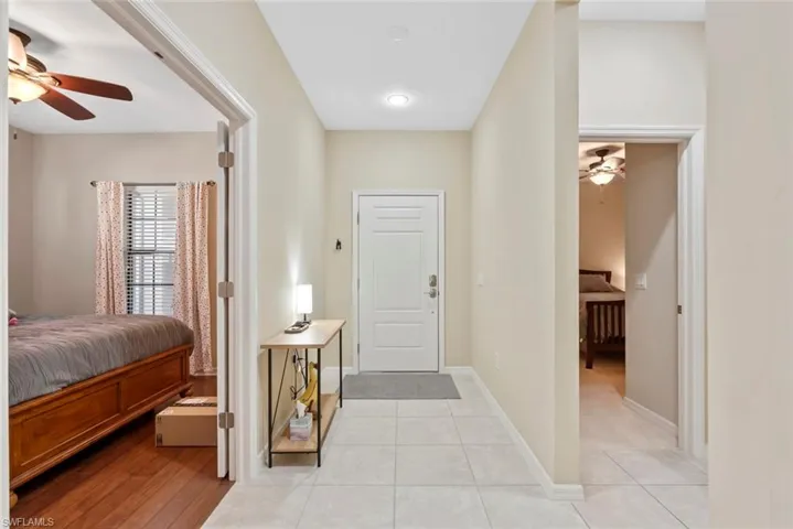 Tiled entryway featuring den on left & bedroom on right