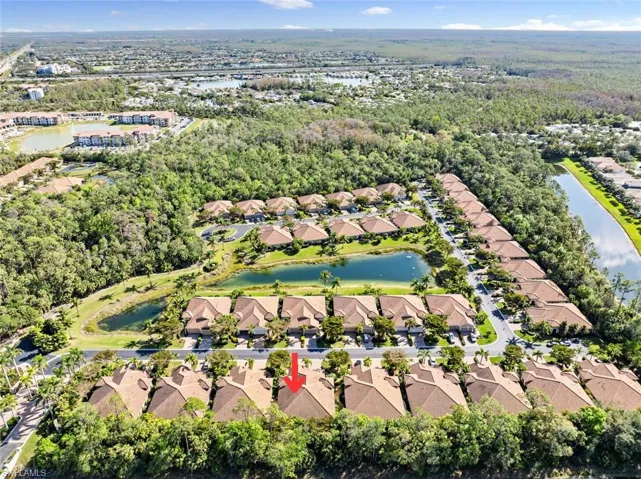 Birds eye view of property with a water view