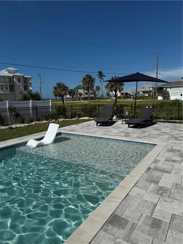 View of swimming pool with a fenced backyard and a patio area