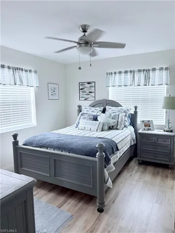 Bedroom with light wood-type flooring and a ceiling fan