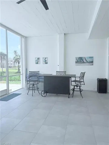 Living room with a wall of windows and wooden ceiling