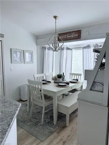 Dining area with light wood finished floors and a chandelier