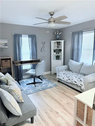 Bedroom featuring wood finished floors, ceiling fan, and multiple windows