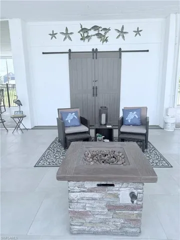 View of patio featuring an outdoor living space with a fire pit