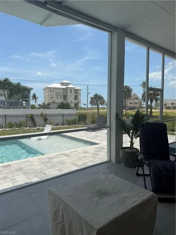 View of pool featuring a sunroom
