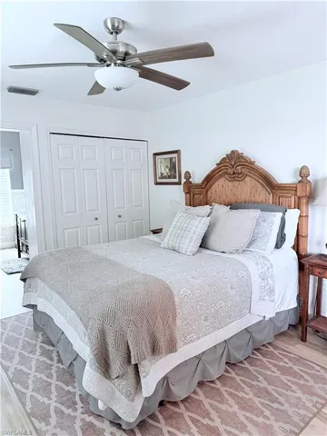 Bedroom with a closet, a ceiling fan, and light wood-style floors