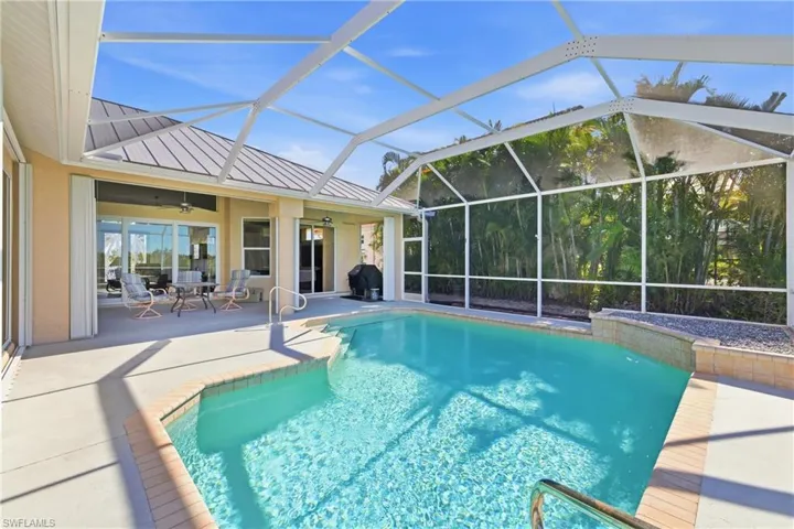 Outdoor pool featuring a lanai, a sunroom, a patio, and outdoor dining space