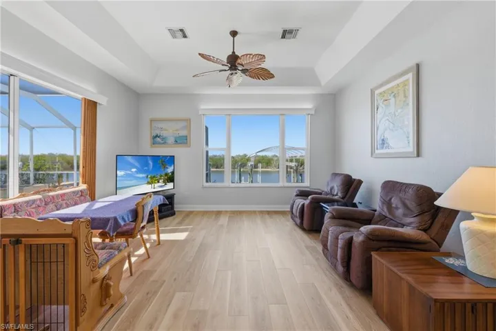 Family room, a ceiling fan, and a raised ceiling