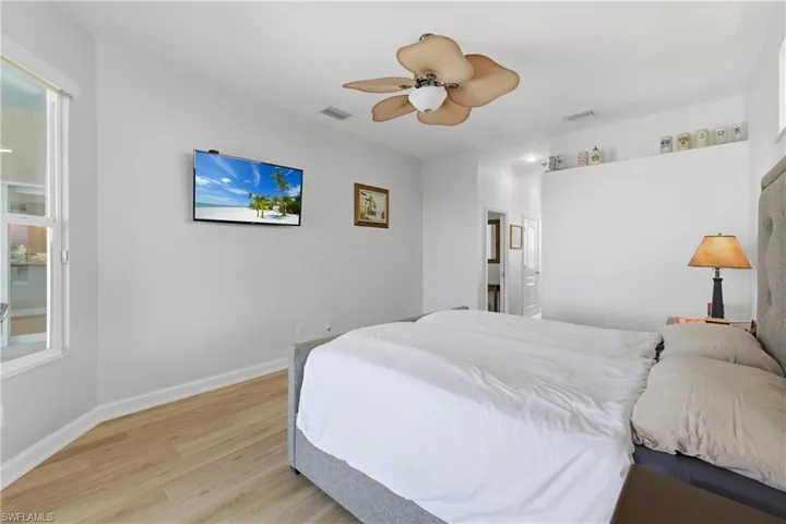 Bedroom with light wood-type flooring and a ceiling fan