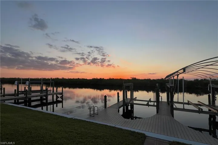 10000# lift and 3000# lift Dock area featuring boat lift, a yard, and a water view