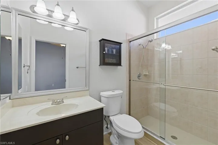 Bathroom with a stall shower and vanity