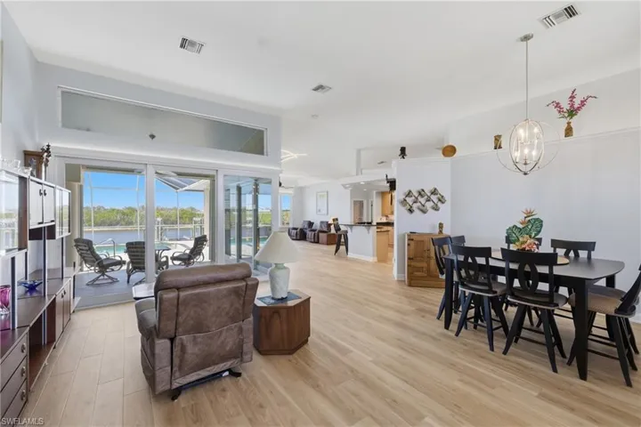 Living room with views of pool and canal through zero edge slider