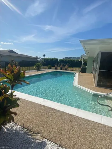 Shallow pool end with steps and handrail next to the open patio