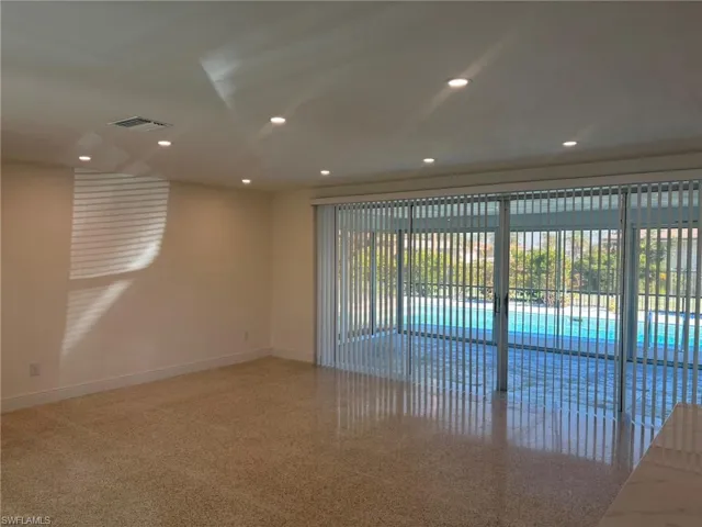 The Living area opens onto the Lanai with 2 sets of oversized sliding glass doors and features recessed ceiling lighting and polished Terrazzo flooring