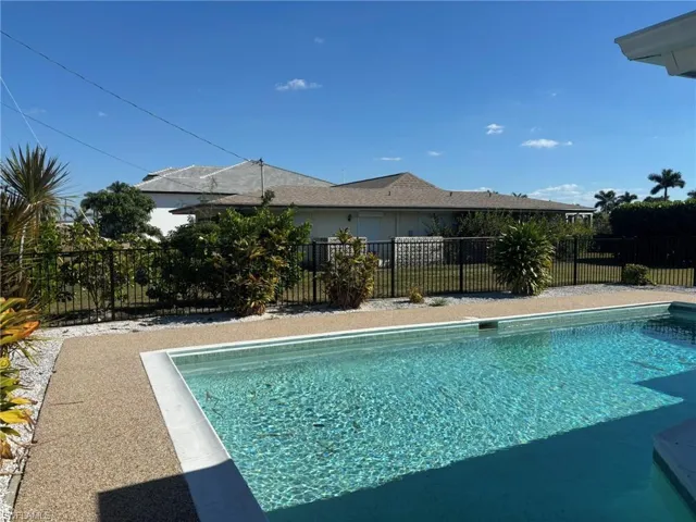 Attractive open pool with metal fencing enclosure and additional rock areas for your personal plants and decorations. Pool care is included