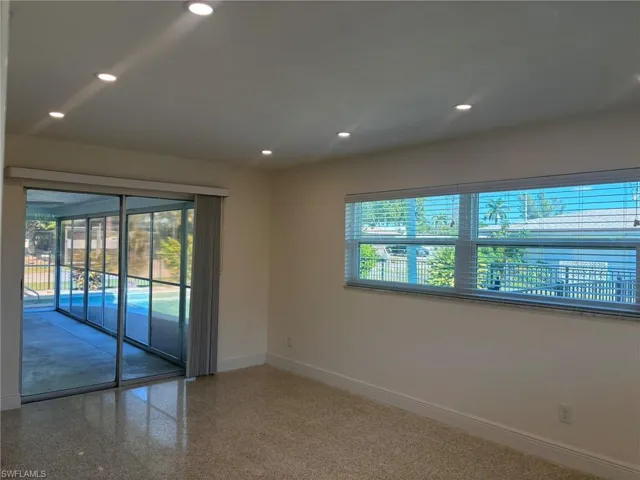 Primary Bedroom features a private slider entrance to the screened Lanai and Pool.
