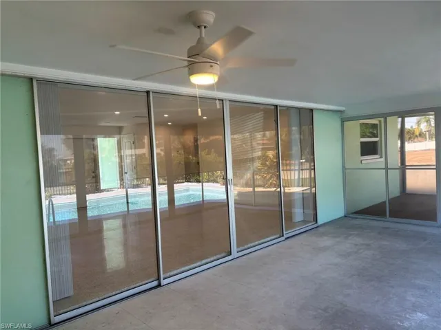 Lanai with siding pocket doors to living area, multiple entrances to the swimming pool and lighted ceiling fan.