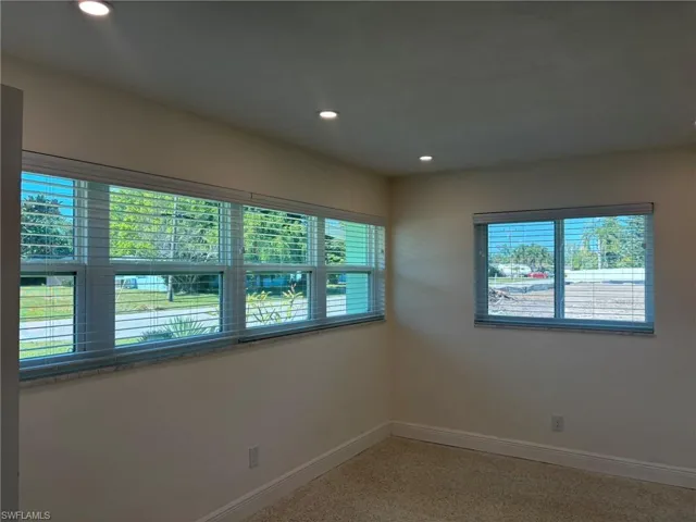 Front guest Bedroom is light and bright with plenty of windows, Terrazzo floors and quality custom blinds.