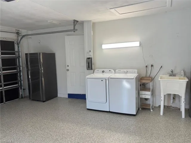 The 2 CAR GARAGE features an additional "garage" Refrigerator, Washer and Dryer and utility sink.