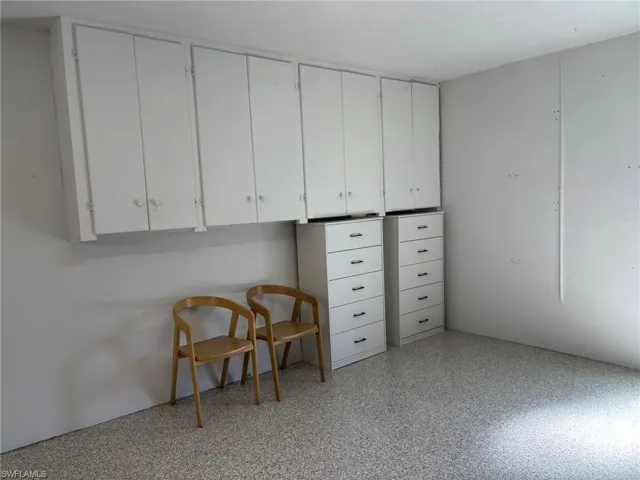 The rear of the 2 CAR GARAGE has additional storage and a side entry door