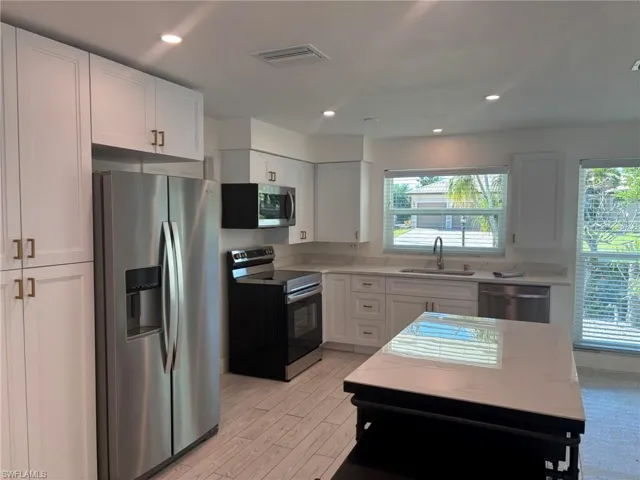 Extra Kitchen features are the deep stainless-steel sink with goose neck faucet and soap dispenser, Refrigerator with ice and water, pantry and lazy susan cabinet.