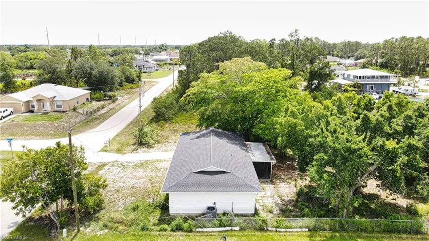 View from above of property featuring a tree filled landscape