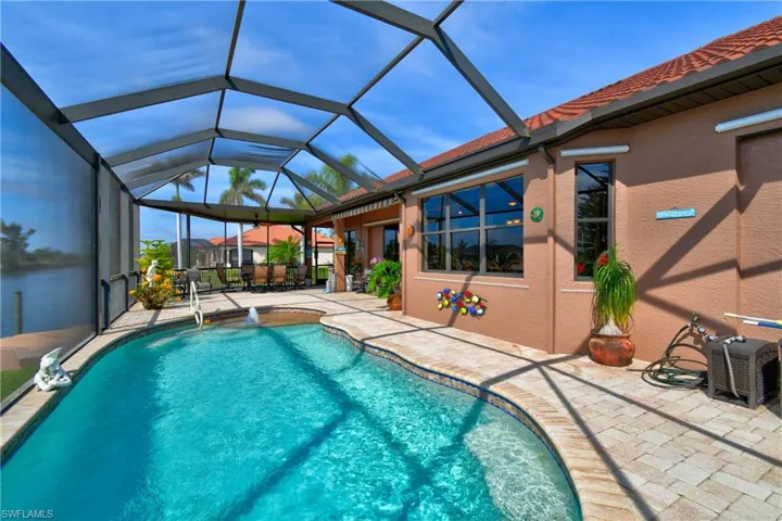 View of pool featuring a patio, a lanai, and pool water feature