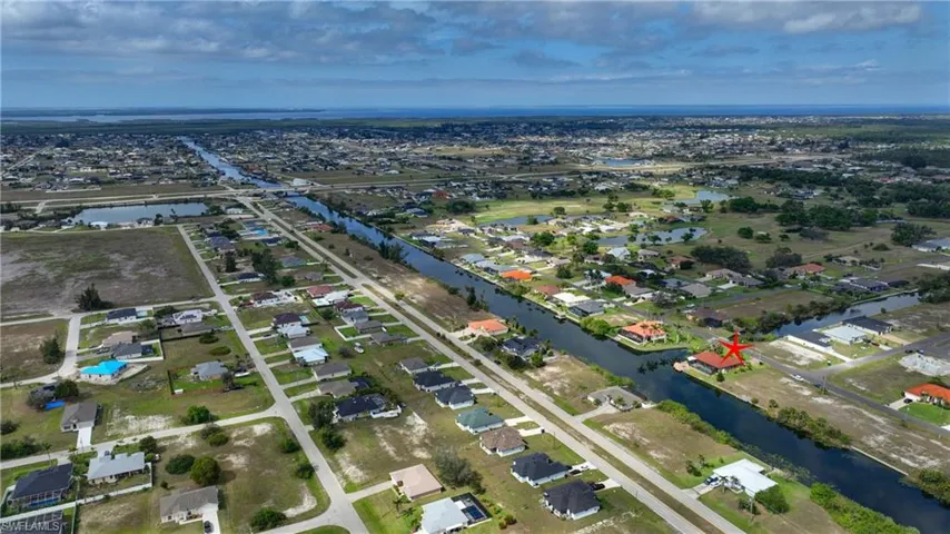 Birds eye view of property with a water view